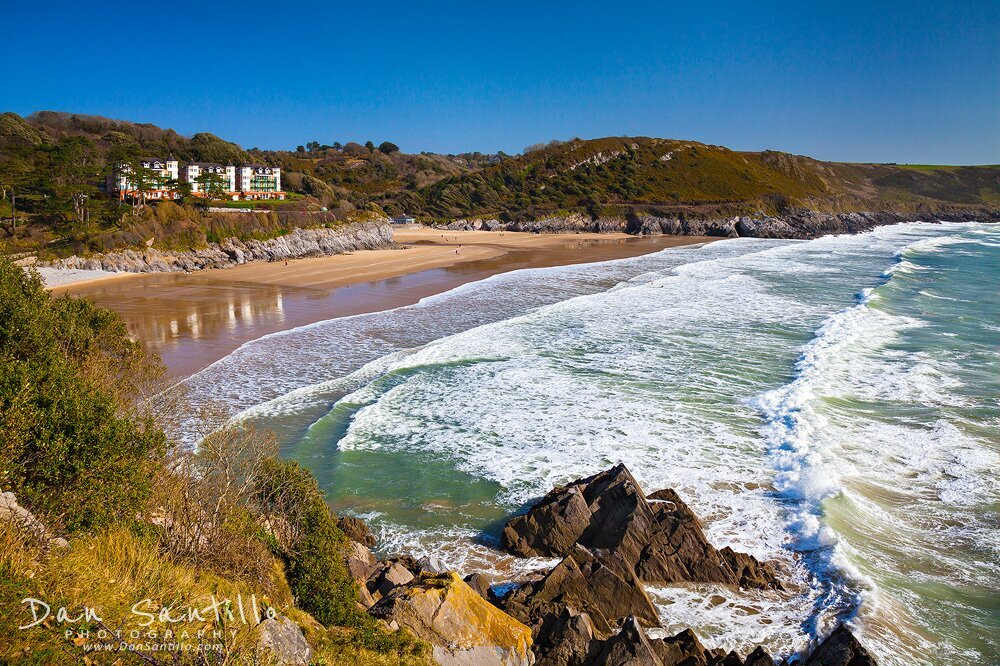Dan Santillo 30cm x 40cm framed print featuring Caswell Bay's scenic coastline.