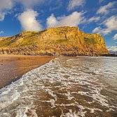 Dan Santillo glass coaster featuring Mewslade Bay coastal scenery.