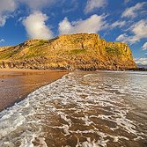 Dan Santillo glass coaster featuring Mewslade Bay coastal scenery.