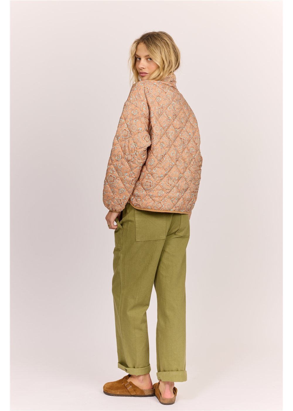 Angled back view of Sisstr Heatin' Up Jacket - sweet clay, showcasing quilted design and casual fit in 100% polyester fabric.