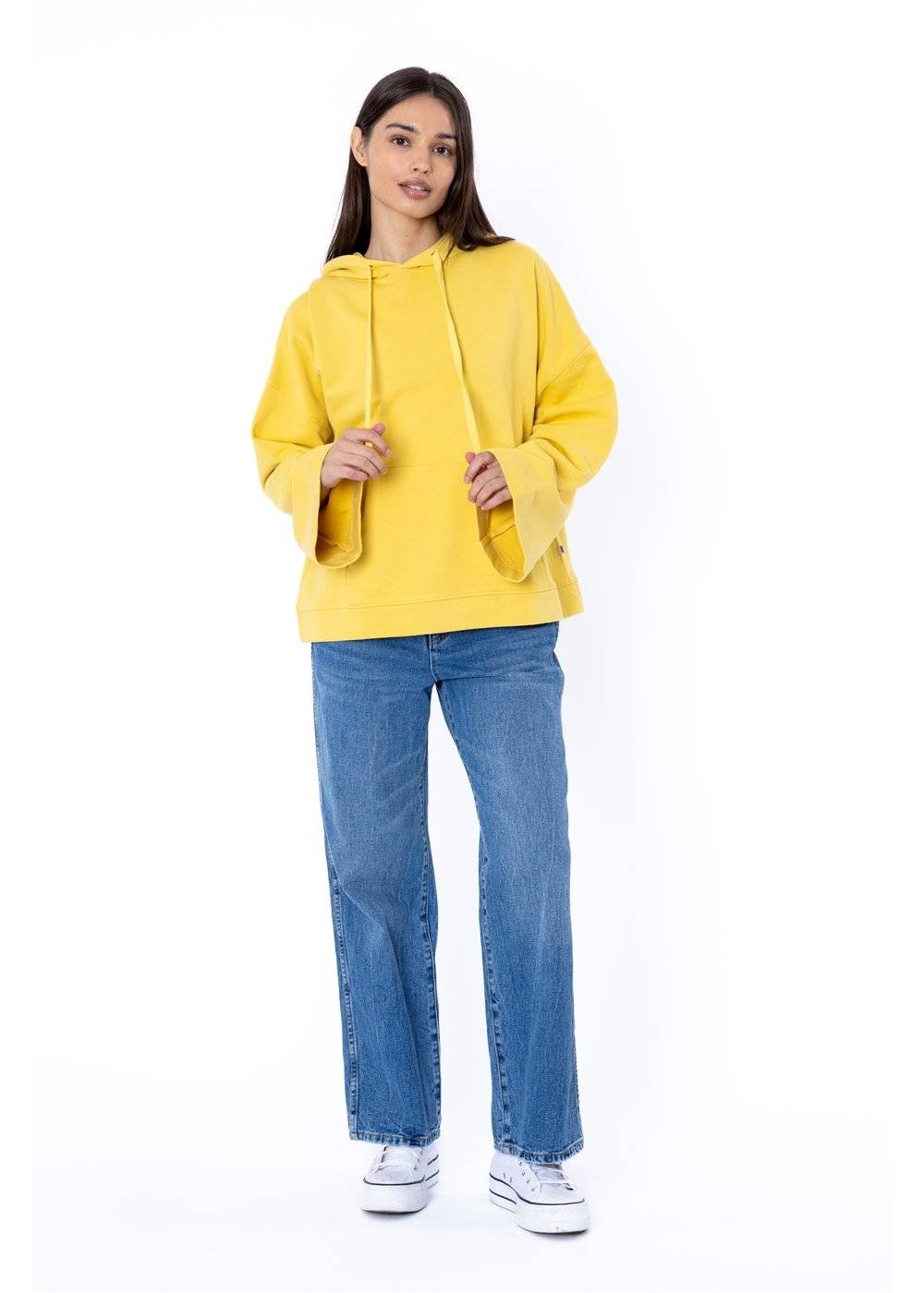 Woman wearing Sisstr Fort Baker Ls Fleece in yellow with bell sleeves and front pocket.