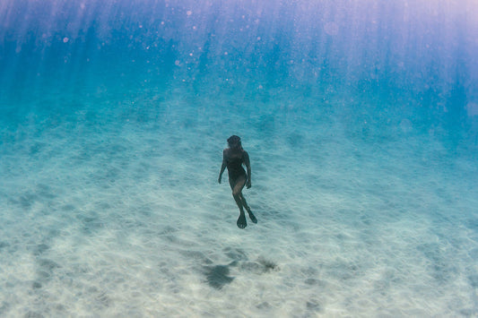 Swimmer with fins underwater ocean