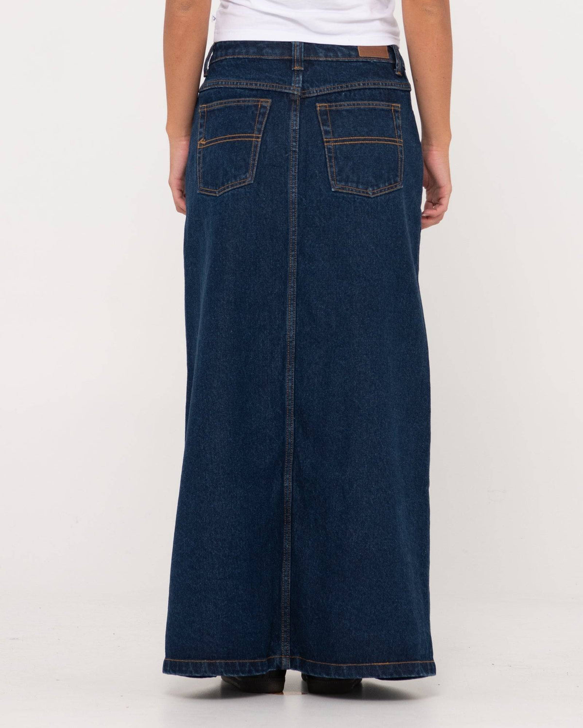 Back view of Rusty Celeste low-rise denim maxi skirt showcasing rear pockets.