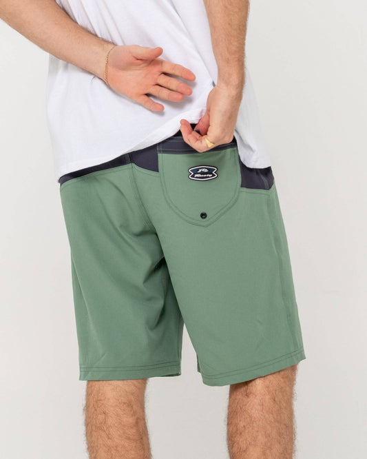Rusty Chop Suey Boardshort with green fabric and back pocket detail, rear view.