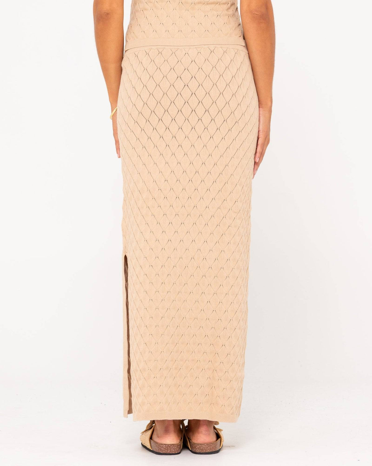 Back view of Rusty Leo Maxi Knit Skirt featuring diamond pattern and side slit.