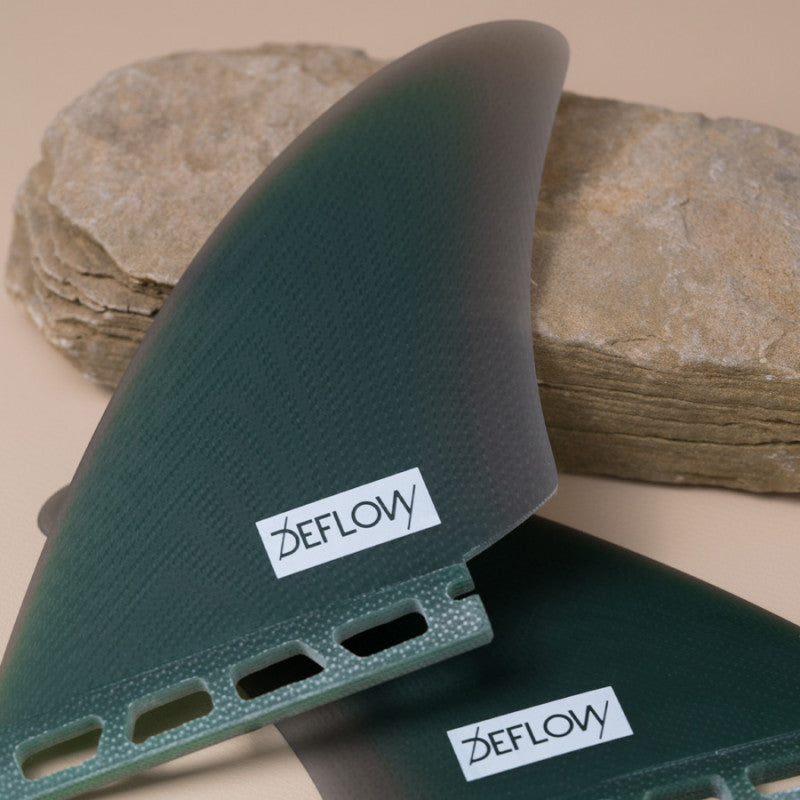 Close-up of Deflow Mid Green twin fins showcasing single tab detail.