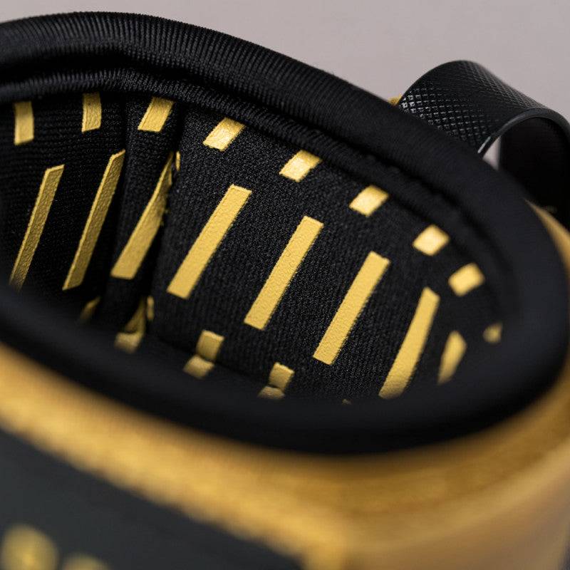 Close-up of Deflow knee leash interior padding with mustard and black accents.