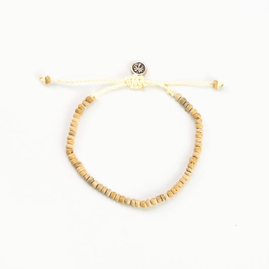 Coconut wood bead bracelet with adjustable cord and button clasp.