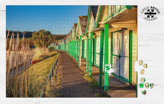 Completed Dan Santillo Langland Bay jigsaw puzzle showing vibrant beach huts.