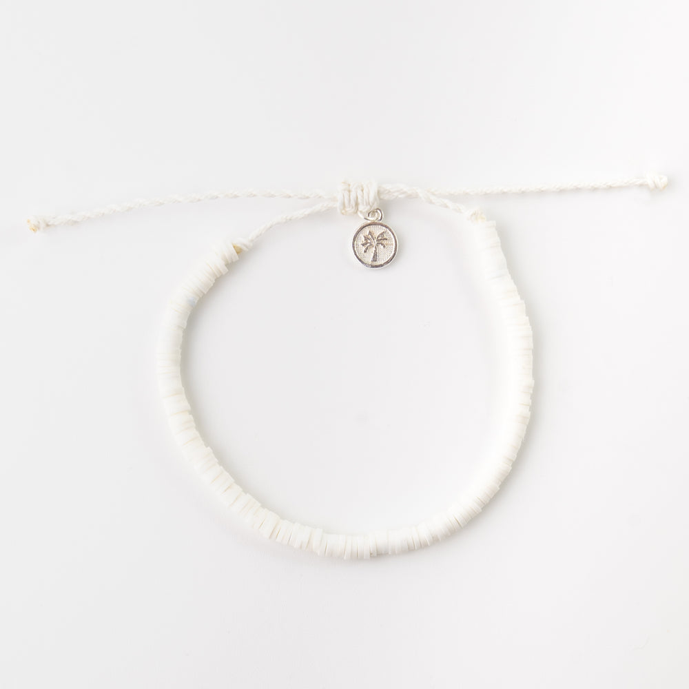 White clay beaded anklet with adjustable cord and charm detail.