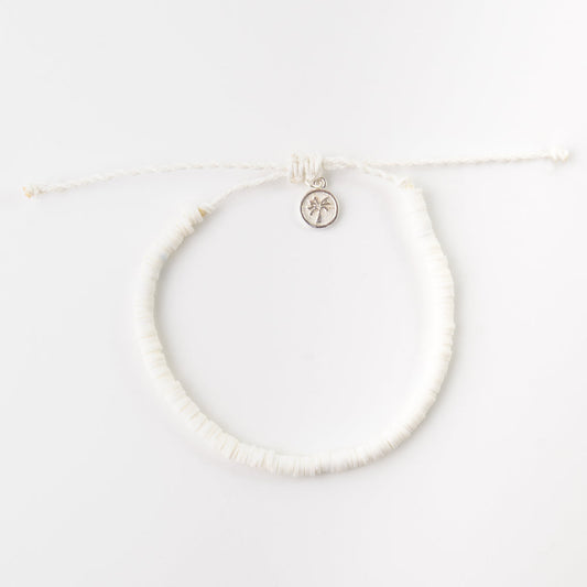White clay beaded anklet with adjustable cord and charm detail.