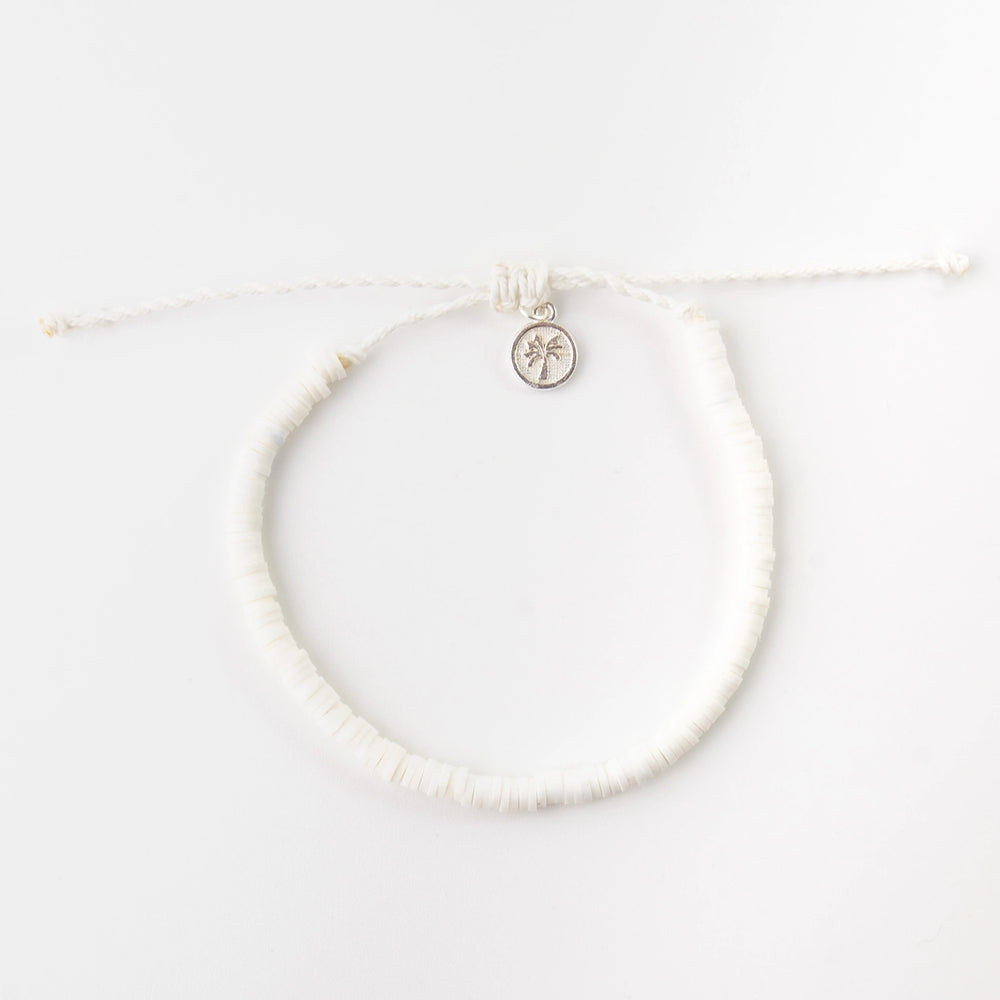 White clay beaded bracelet with charm, adjustable string closure.