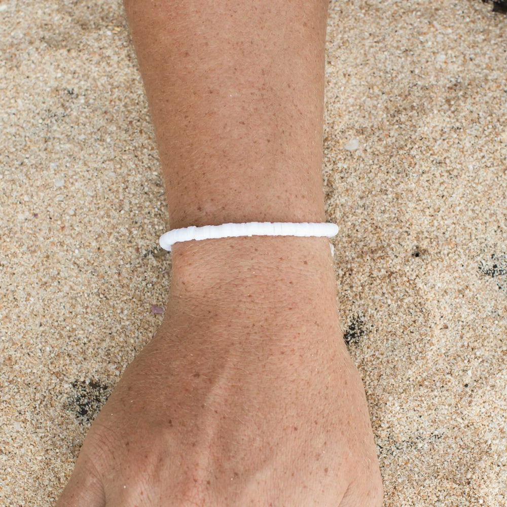 White clay beaded bracelet worn on wrist, minimalist beach style.