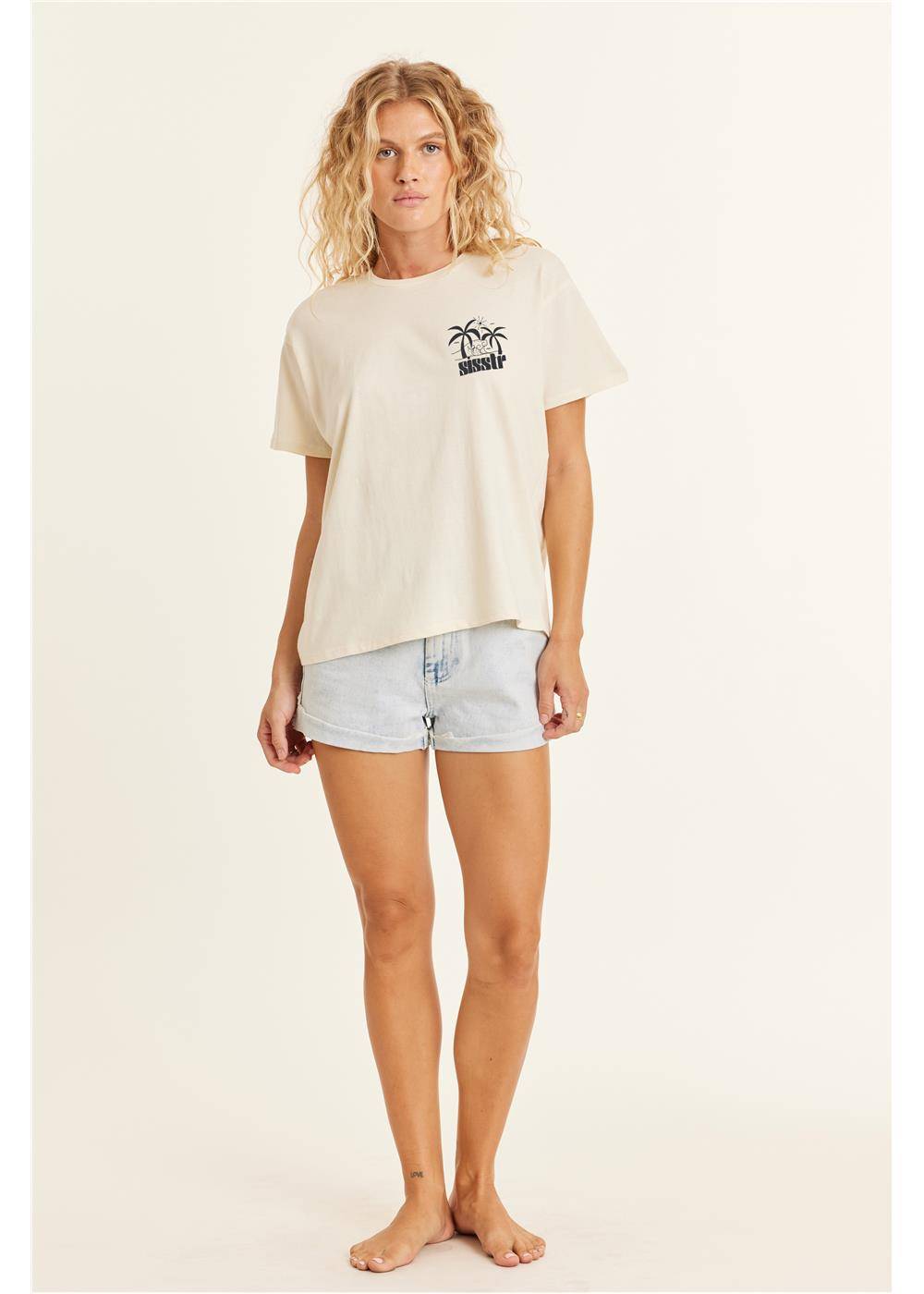 Sisstrevolution Retro Beach Boyfriend Knit Tee with palm tree print on chest, modeled with denim shorts.