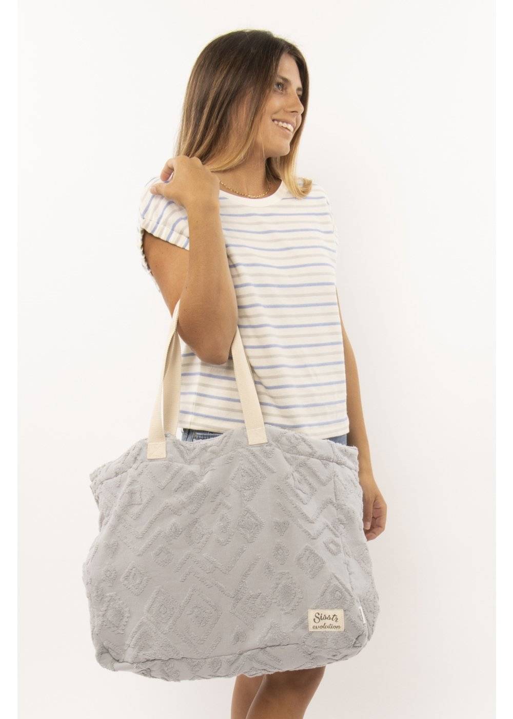 Gray Sisstr Towel Tote with textured pattern, displayed on a model.