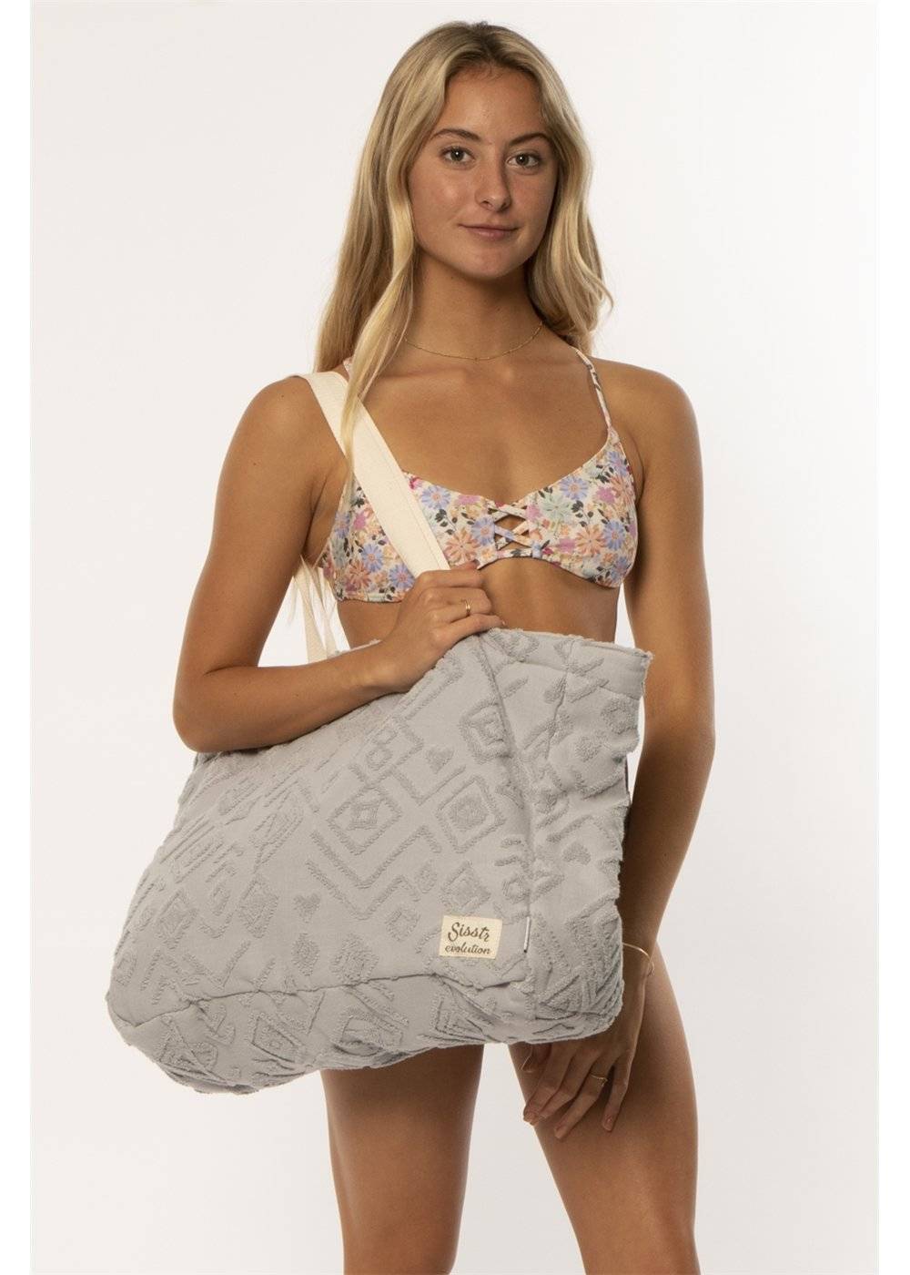 Sisstr Towel Tote in gray with textured design, carried by a model.