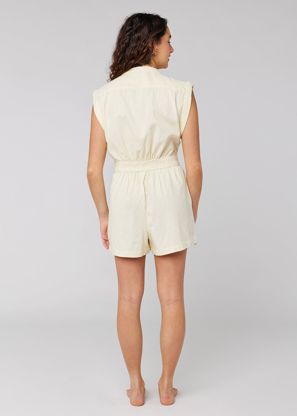 Sisstrevolution In My Sol Romper in white sand, back view with elastic waistband.
