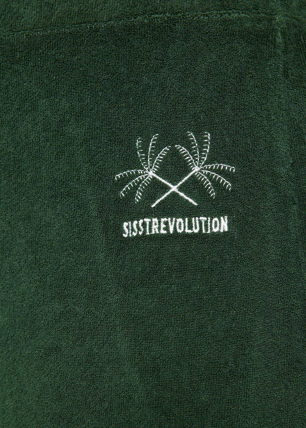 Close-up of Sisstrevolution Sofia Pant logo with palm tree embroidery in North Green.