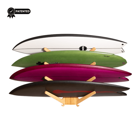 Side view of bamboo surfboard rack holding four boards of various colors.