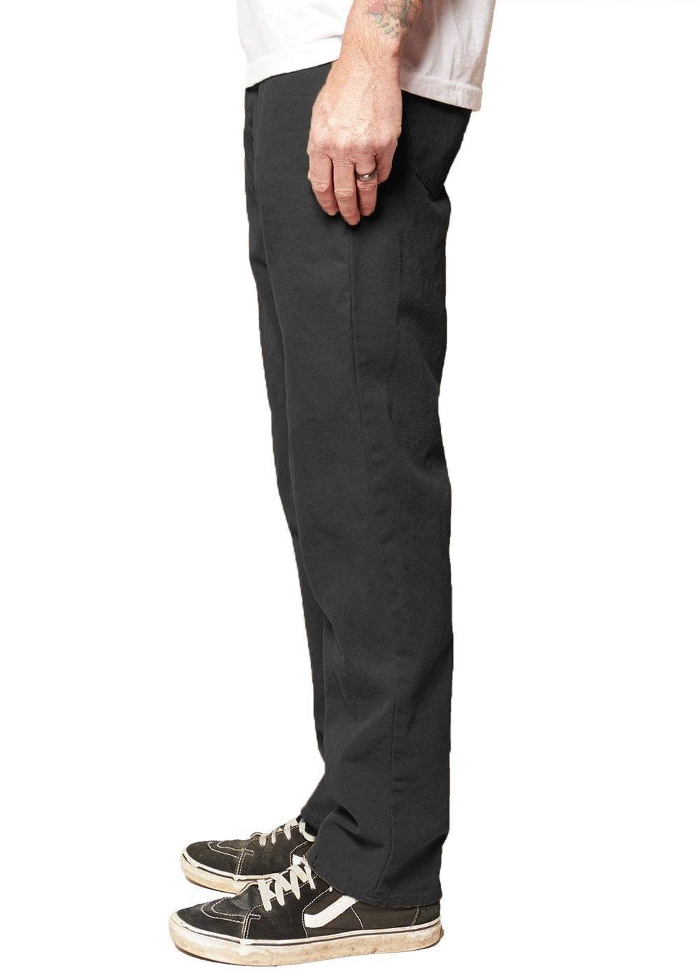 Side view of Vissla Border Canvas 5 Pkt Pant worn by a model.