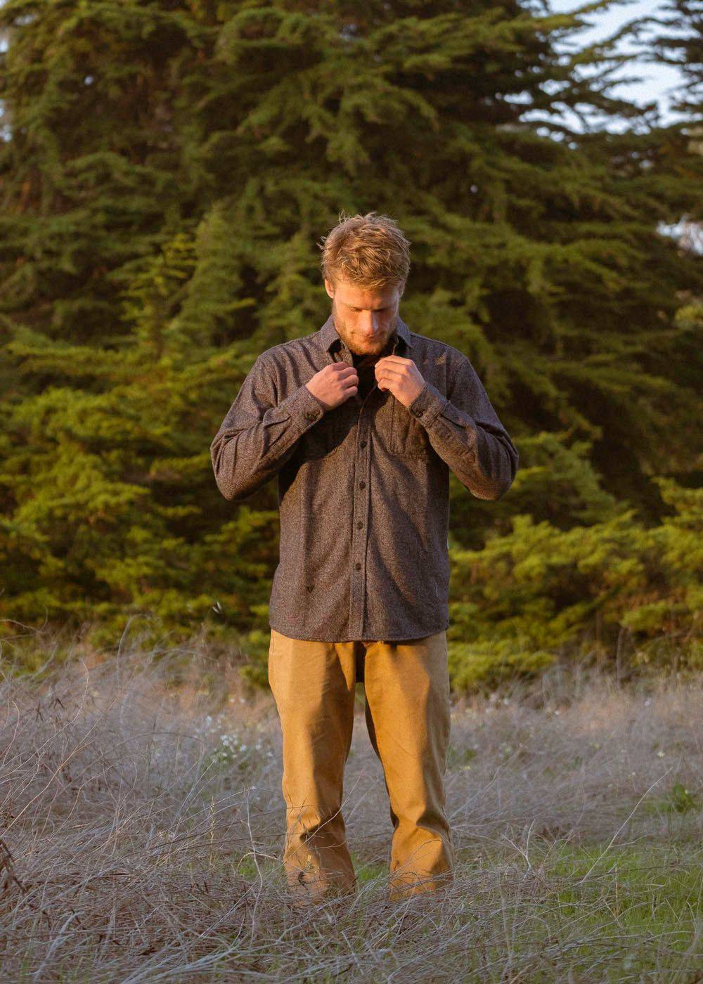 Man wearing Vissla Shaper Eco Flannel, black, outdoors in nature.