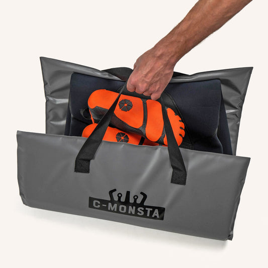 C-Monsta Changing Mat in gray with durable handles, holding orange gear.