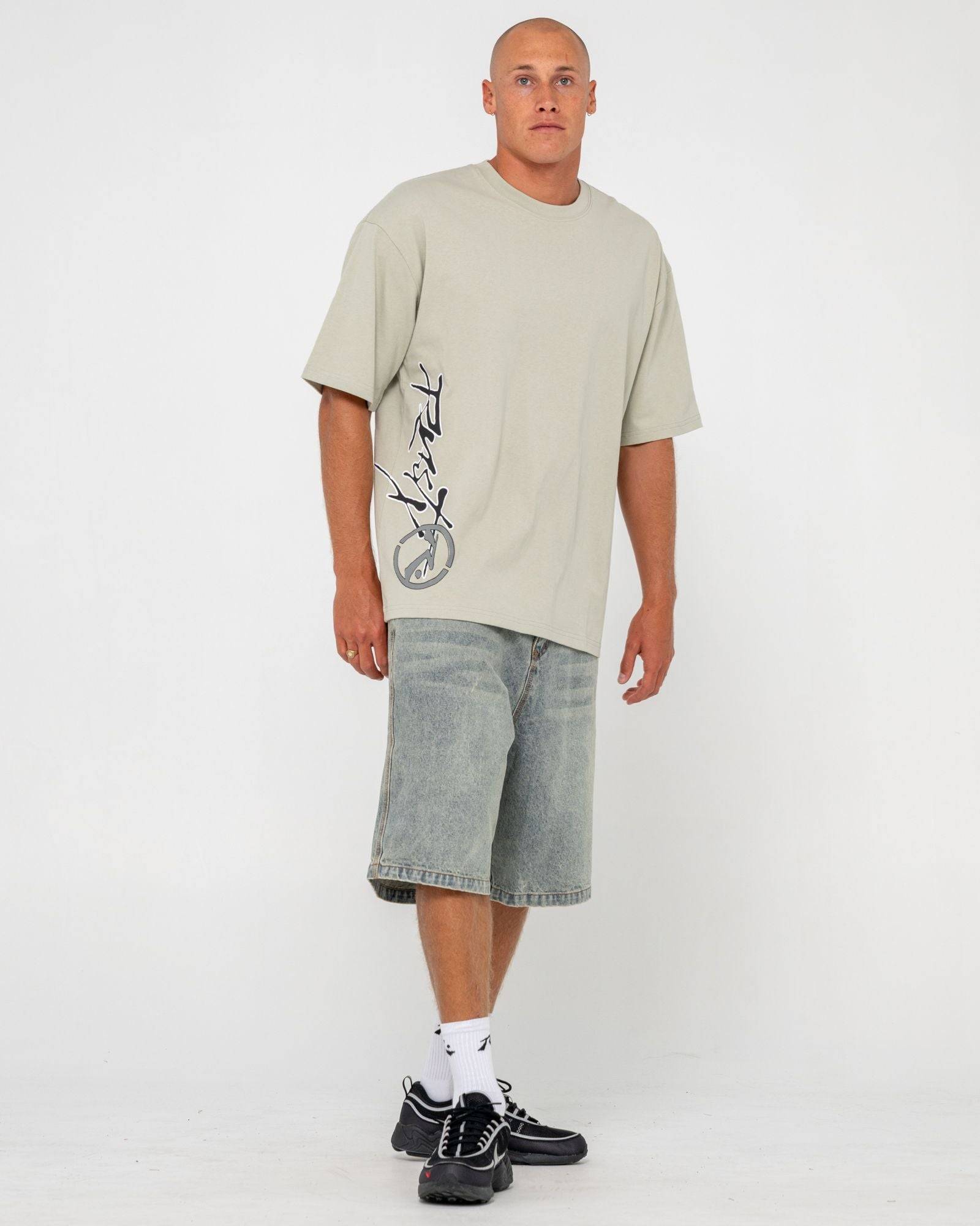 Men's beige graphic tee with black and white logo design, short sleeves, casual style