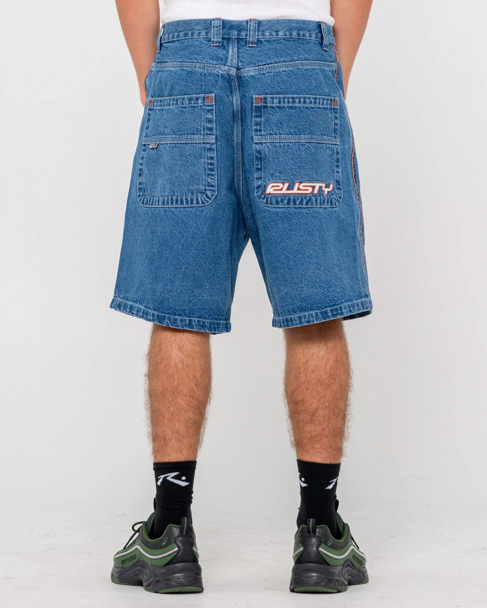 Back view of men's denim walkshorts with logo patch
