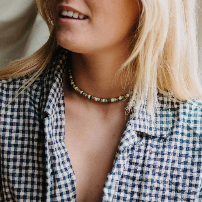 Woman wearing Pineapple Island Laut turquoise wood necklace with casual outfit.