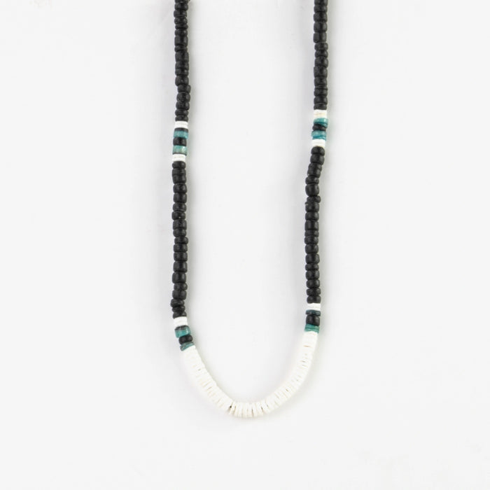 Close-up of Pineapple Island Marley surf bead necklace with black and white beads.