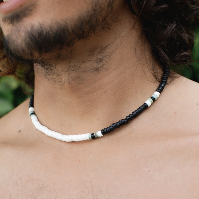 Marley surf bead necklace with black and white beads worn on a neck.