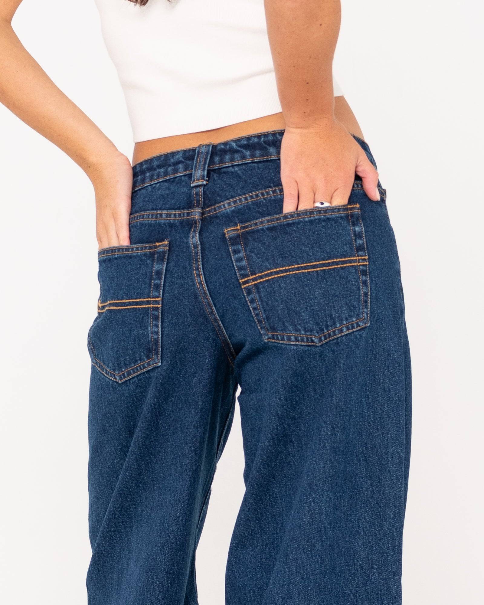 Close-up of back details on Rusty Low Rise Super Wide Leg Jean with stitching.