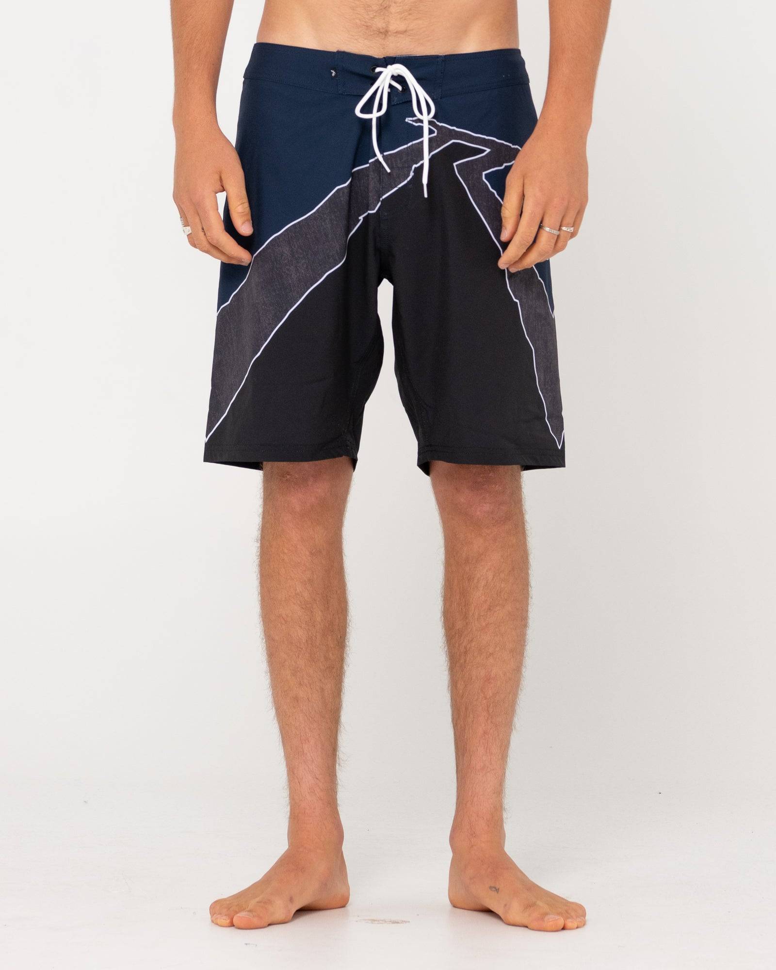 Rusty Illusion Boardshort with geometric design, front view.