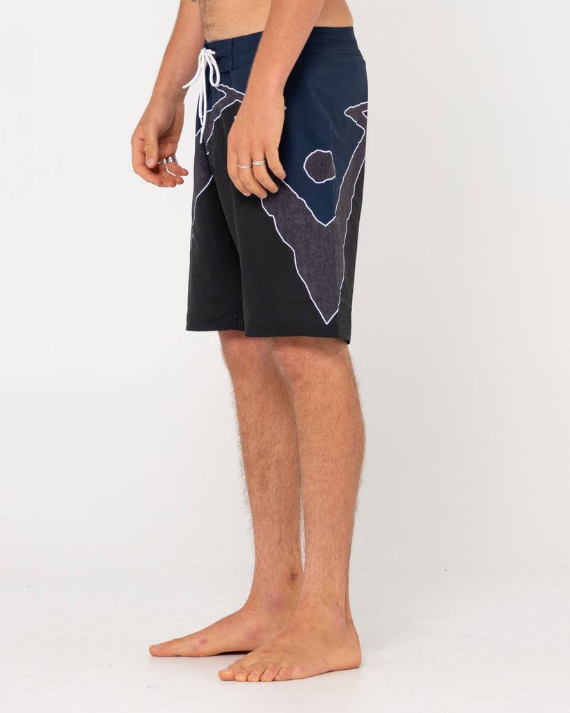 Rusty Illusion Boardshort with geometric design, side view.