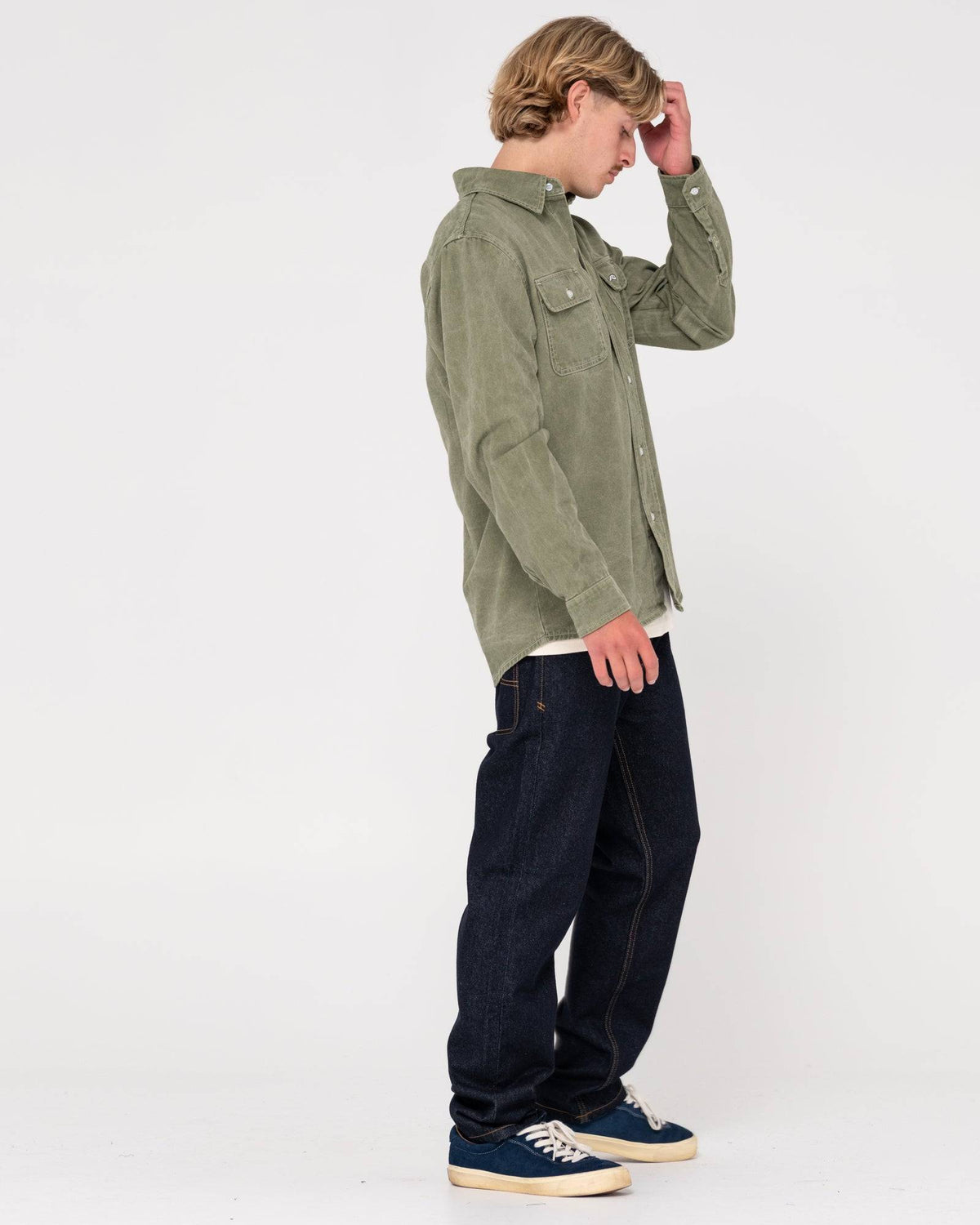 Model wearing Rusty Steven Straight Fit Jean styled with a green shirt and sneakers.