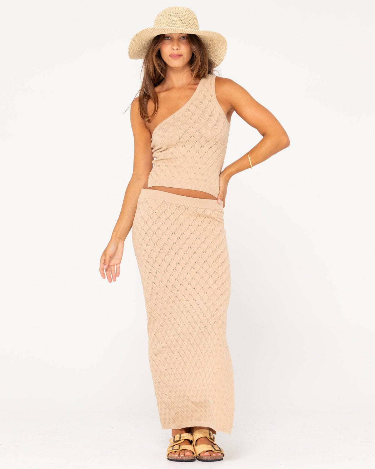 Rusty Leo one shoulder top paired with matching beige skirt for a chic look.