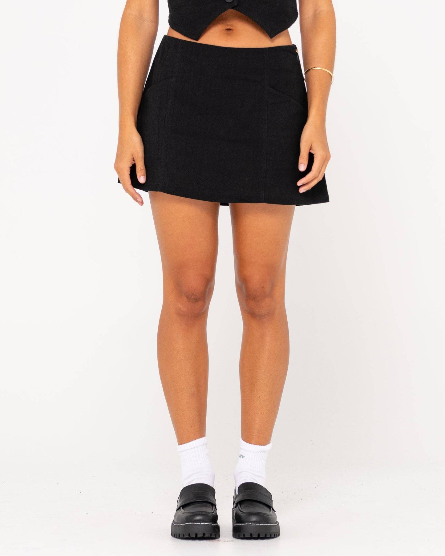Front view of Rusty Sicily Mid Rise Mini Skirt in black.