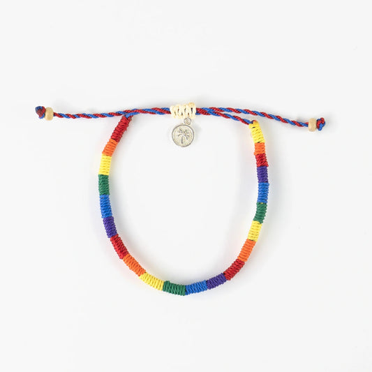 Pineapple Island woven pride bracelet with rainbow colors and charm.