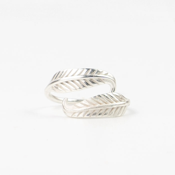 Close-up of Pineapple Island Bocca Feather Ring in silver on white background.