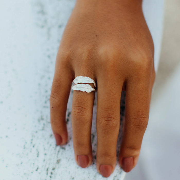 Pineapple Island Bocca Feather Ring in silver displayed on a hand.