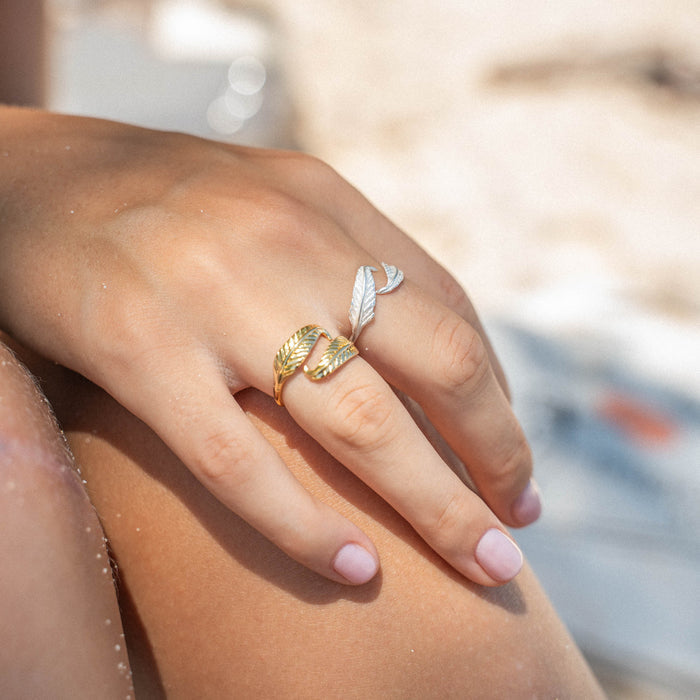 Gold Pineapple Island Bocca Feather Ring worn on a hand, showcasing its elegant design.