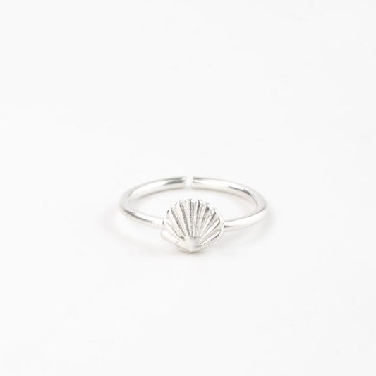 Minimalist silver shell adjustable ring displayed on a white background.