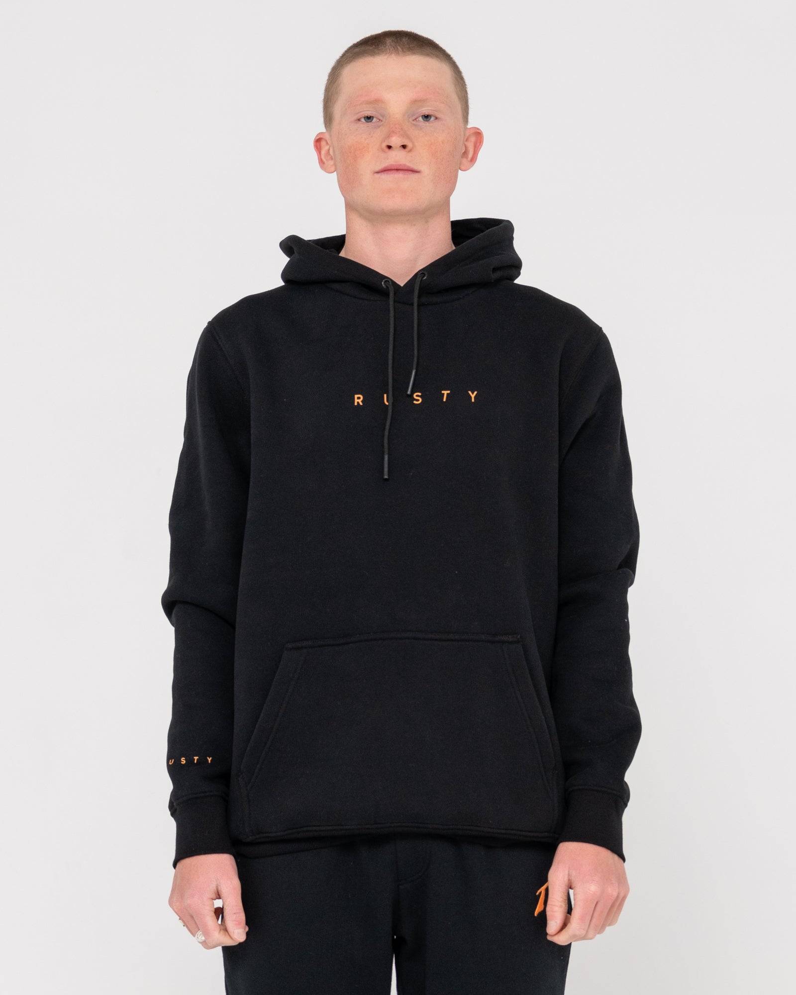 Front view of Rusty Short Hooded Fleece - Standard Fit Hoodie in black with orange logo, featuring kangaroo pocket and drawstring hood.