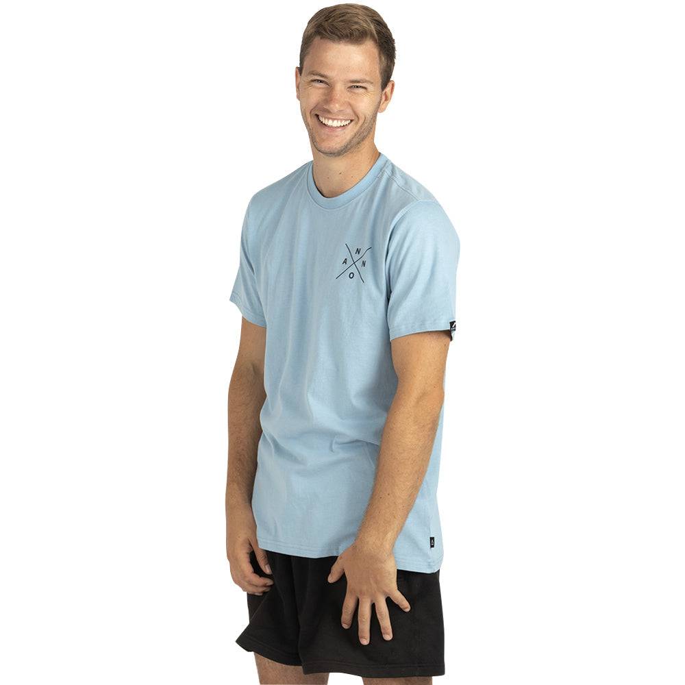 Light blue Annox T-shirt with front logo, worn by a smiling model.