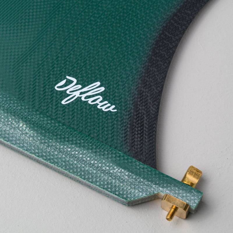 Close-up of Deflow Cream green longboard fin with brass screw detail.