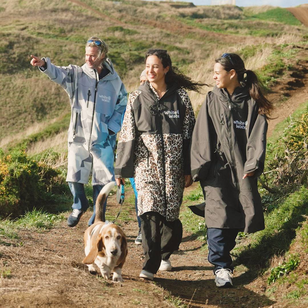Group outdoors wearing White Water robes, including leopard print and solid designs.
