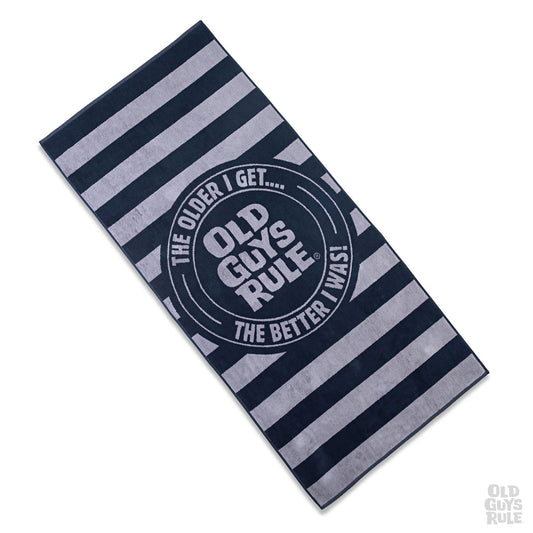 Old Guys Rule 'Stacked Logo Stamp' beach towel in navy and grey stripes with bold circular logo and slogan, ideal for men at the beach or poolside.
